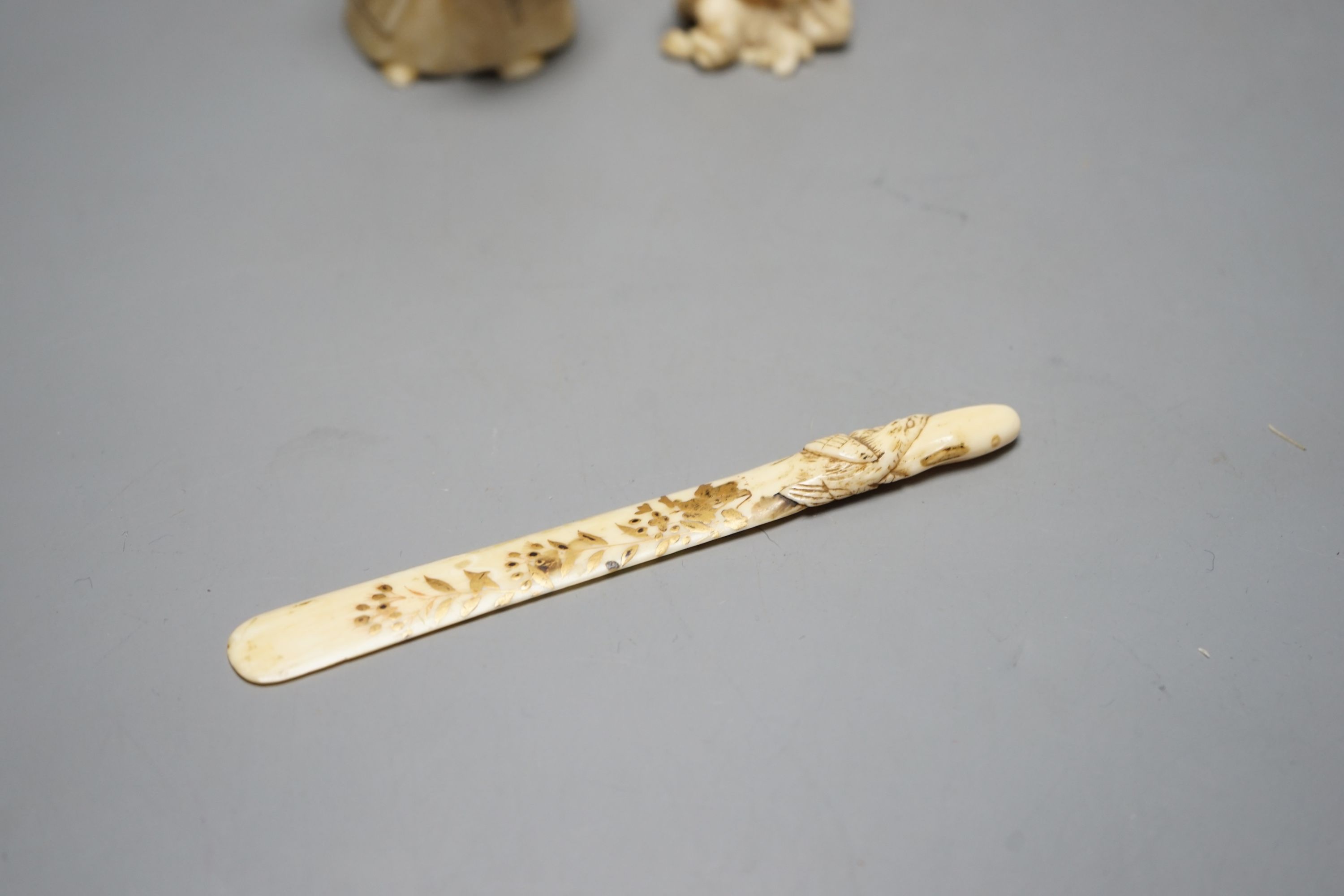 A Japanese face changer, early 20th century, a small okimono of acrobats, Meiji period and an ivory paper knife with lacquer decoration, face changer 8 cms high.